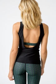 pure by luce sustainable Ana Tulum sleeveless top: black sports vest with open back and Mexican inspired printed detail with the Noemie Tulum green printed leggings